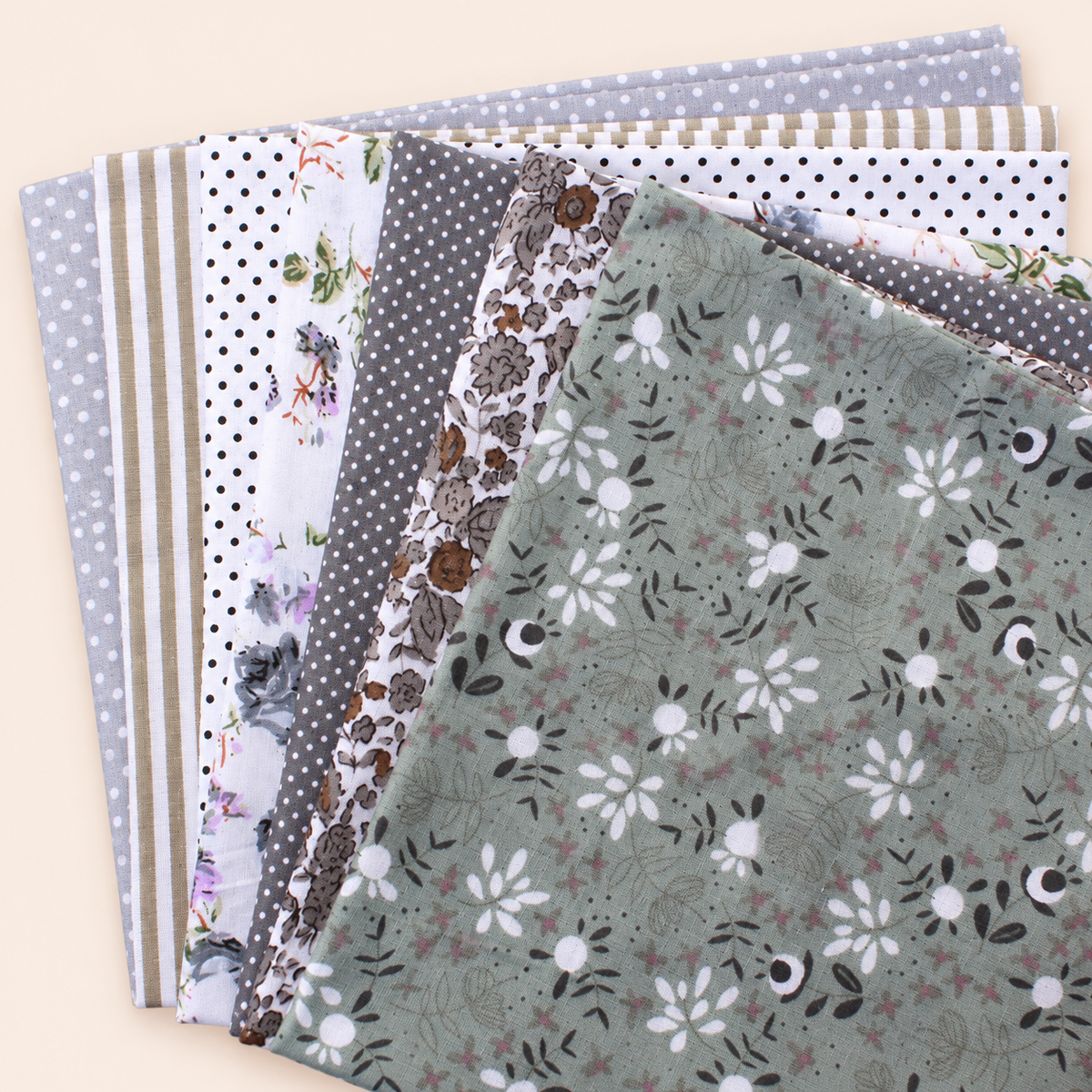 Grey cotton fabric bundle — seven 25 cm squares on cream