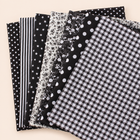 Black cotton fabric bundle — seven 25 cm squares on cream